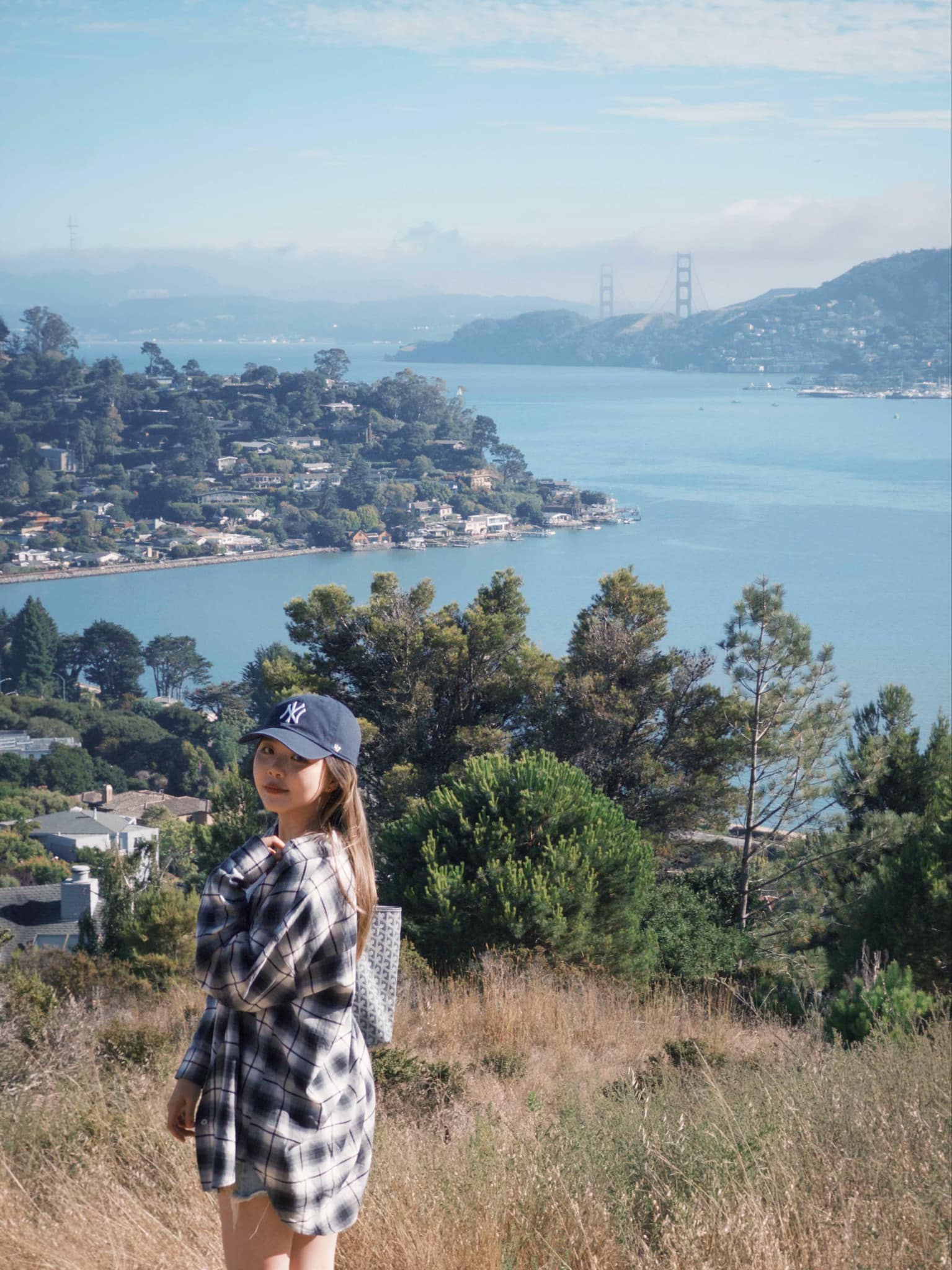 a picture of me standing next to the golden gate bridge from far away